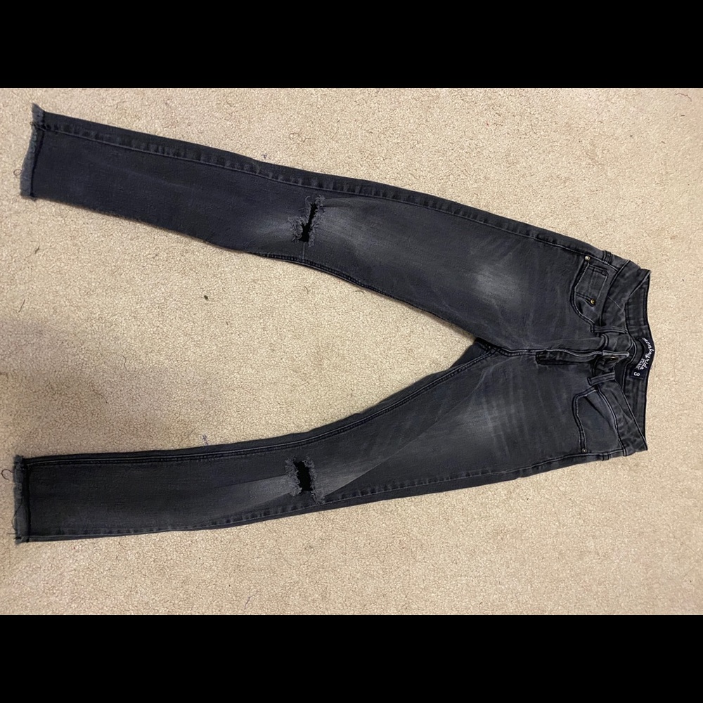 black jeans with rip on the knees